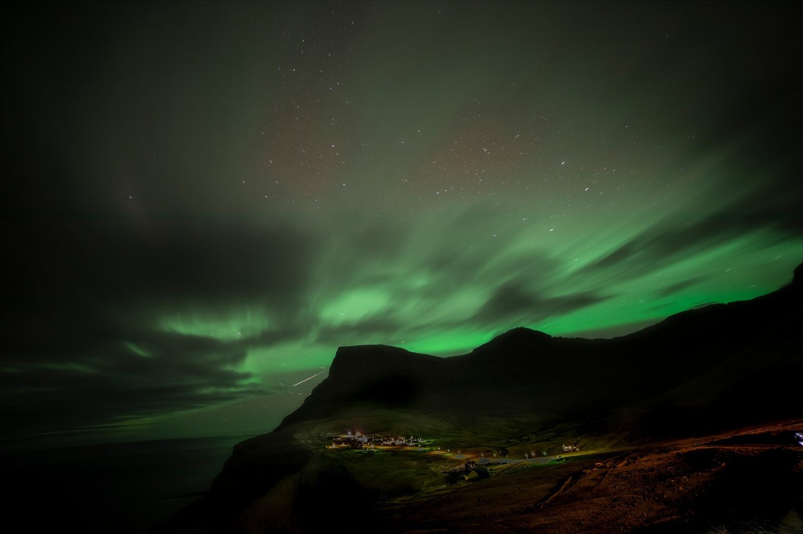 Aurora borealis over gásadalur and Múlafossur
